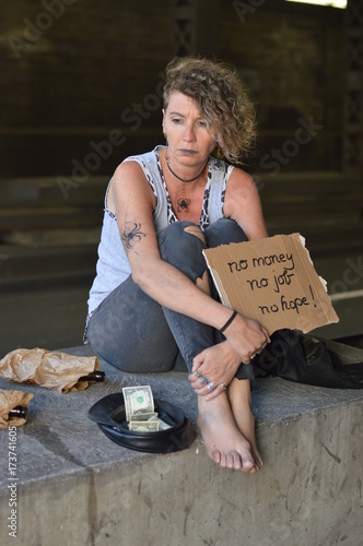 Картината върху платно a homeless punk woman begging, holding a sign - no money no job no hope