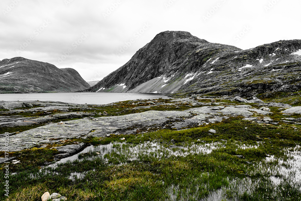 Landscape and snow covered mountains in western Norway with a lake