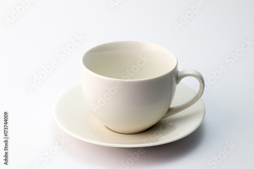 Empty white ceramic teacup and saucer isolated on white background