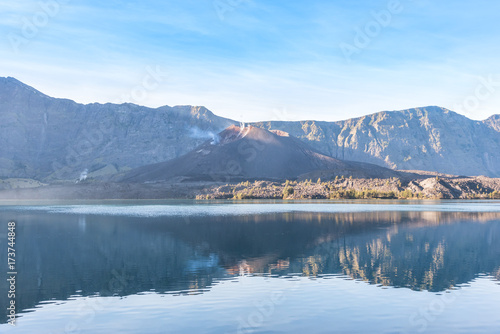 landscape of active volcano Baru Jari, Lake Segara Anak and summit of Rinjani mountain. Lombok island, Indonesia.