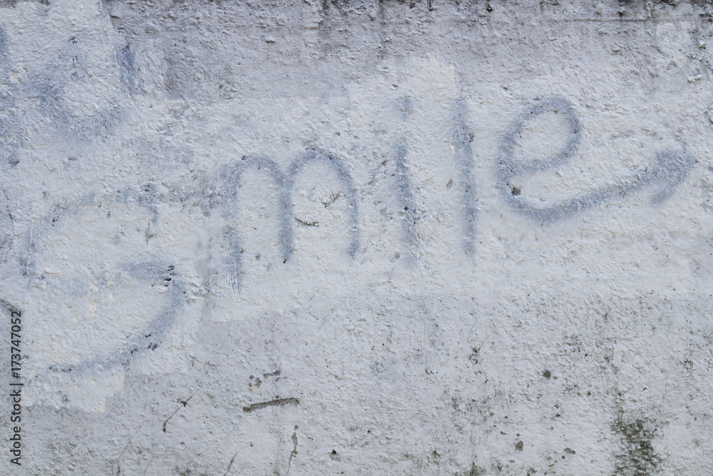 Sign smile on the grey concrete wall. concept Sign smile on the grey concrete wall. concept
