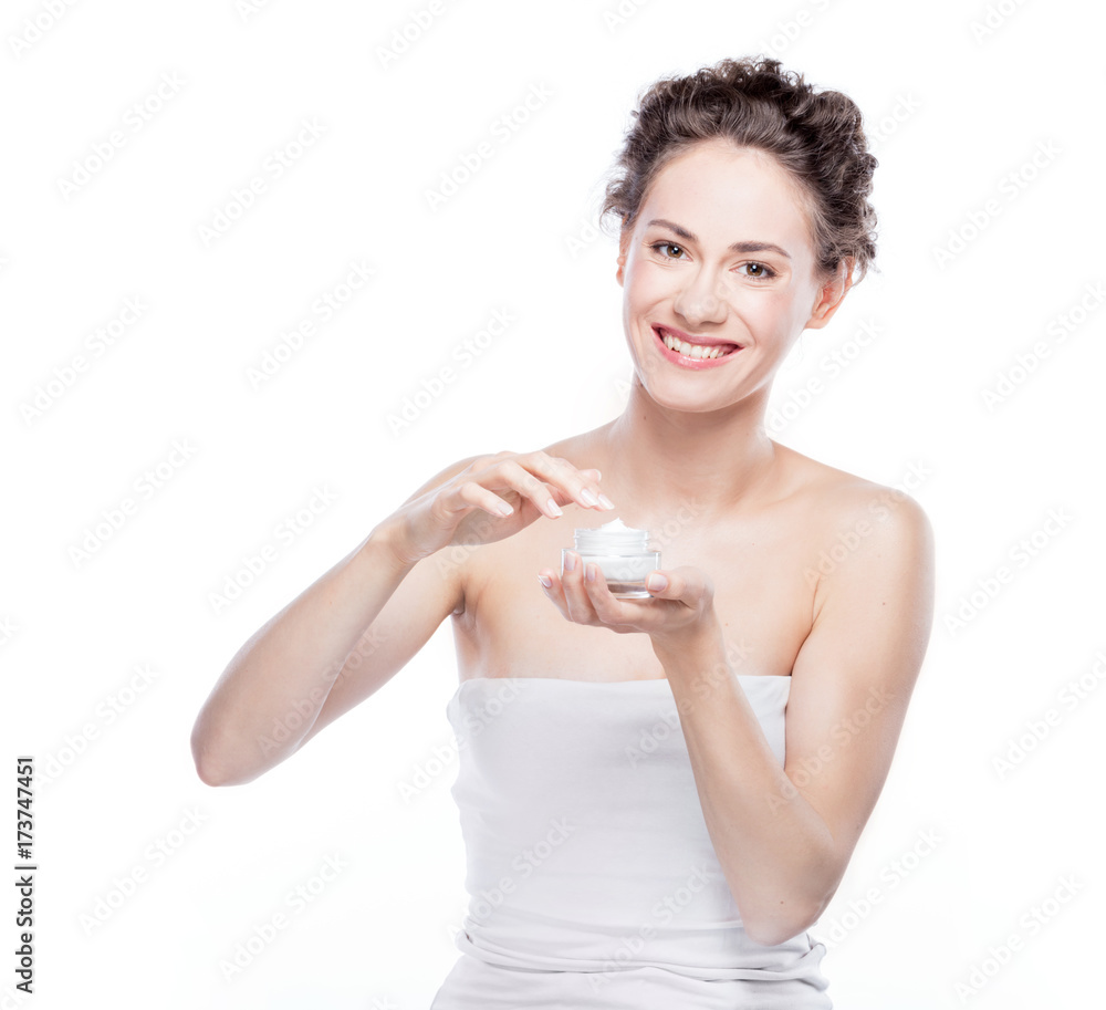 Smiling, attractive woman using a moisturizer. Smiling, attractive woman using a moisturizer.