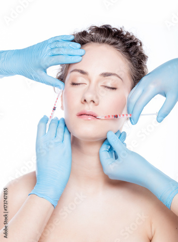 Young woman having multiple face injections.