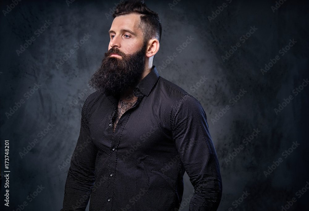 A man in a black shirt with tattoos on his arms. A man in a black shirt with tattoos on his arms.