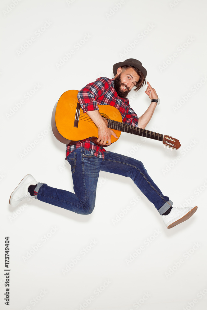 Dynamic man posing with guitar on white