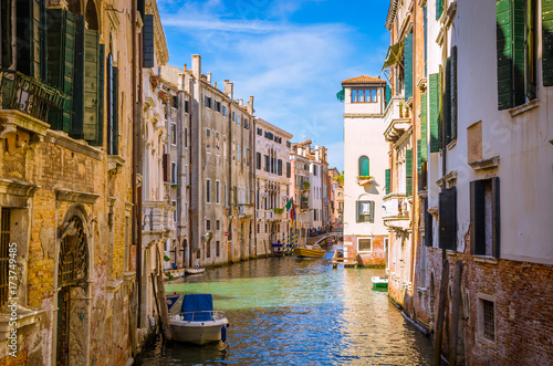 Traditional narrow canal with gondolas in Venice  Italy