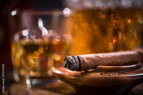 Photography Cuban cigar smoking in wooden ashtray