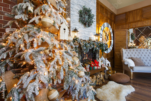 Cozy christmas interior with fir tree and fireplace