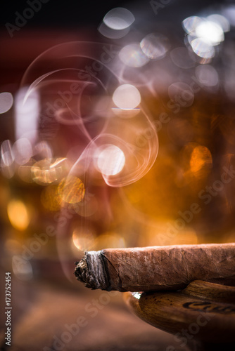 Photography Cuban cigar smoke and luxurious Cognac in carafe