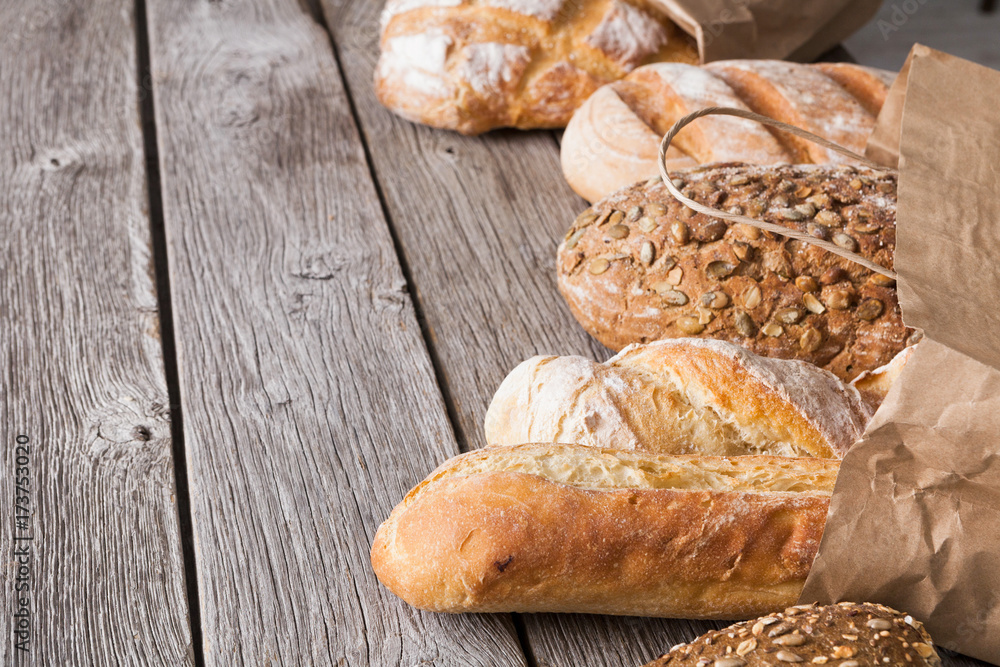 Fototapeta premium Bread background on rustic wood