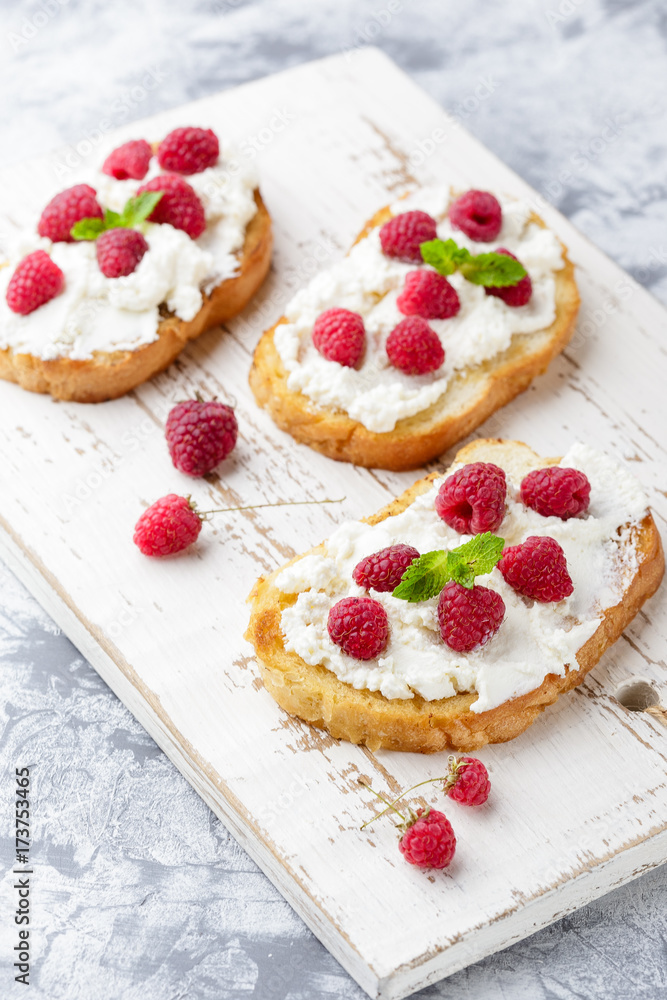 Breakfast slice of bread with Ricotta cheese served with raspberries