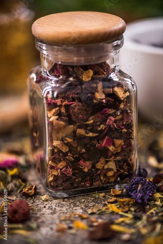 Tea with dried flowers and fruits in jar photo