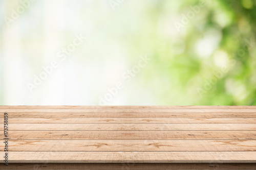 Wood table top on nature green blurred background for montage your products