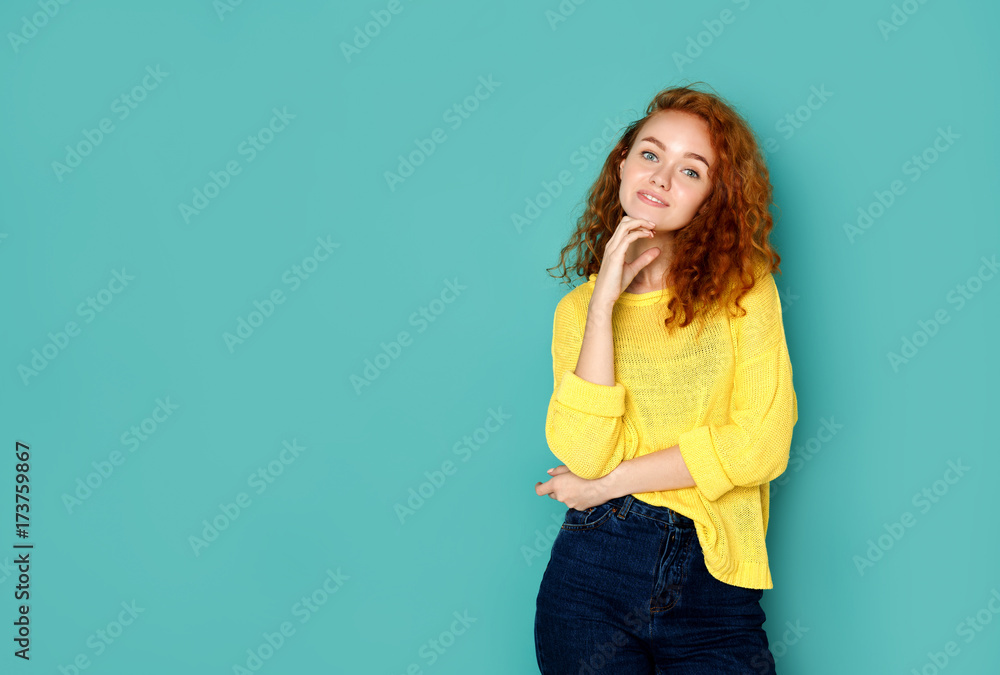 Cheerful girl in casual clothes posing at studio Cheerful girl in casual clothes posing at studio