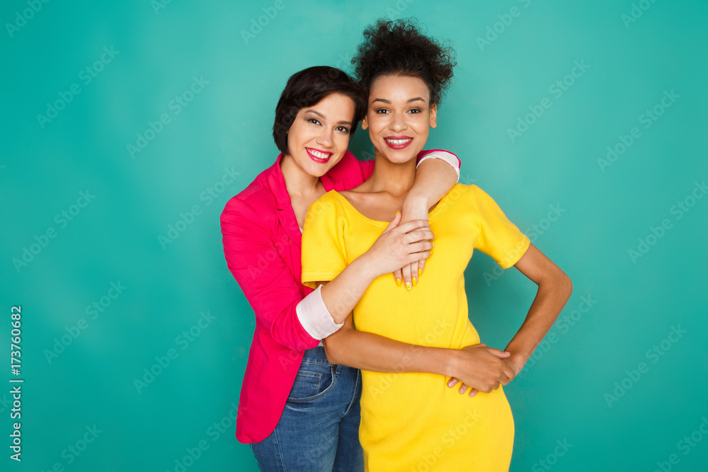 Two girlfriends having fun at azur studio background Two girlfriends having fun at azur studio background