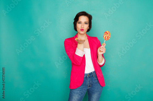 Happy girl in bright casual clothing at studio background