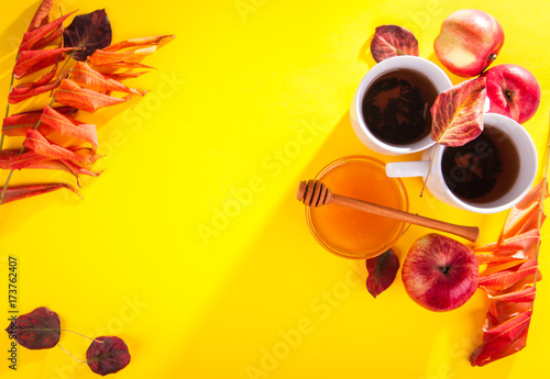 Hot tea with apples and honey on a tray. Autumn harvest