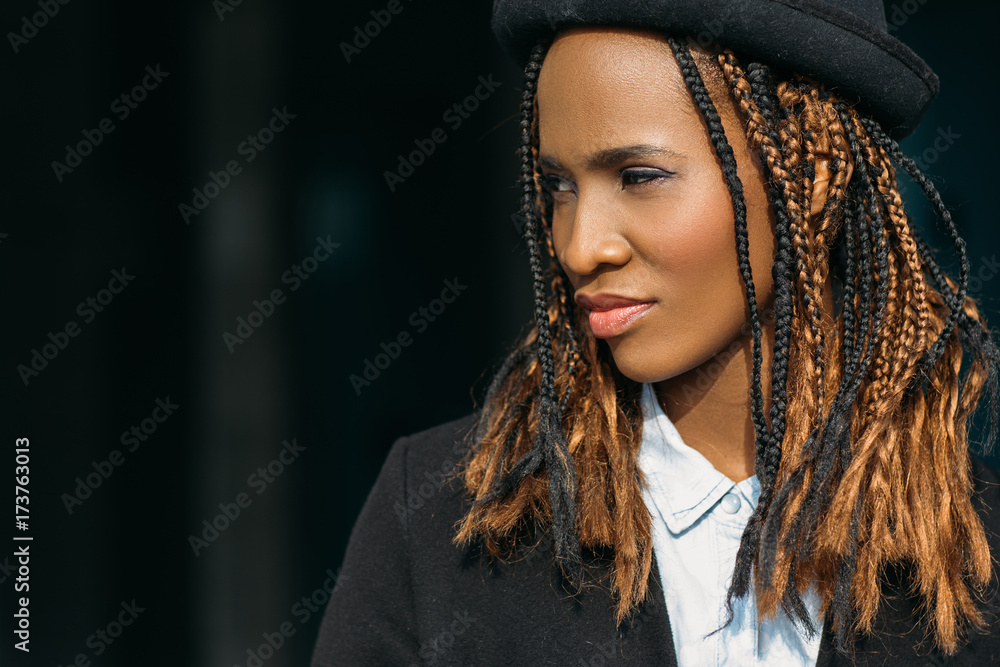 Modern stylish youth. Pretty black female. Young African American woman closeup, dark background with free space, beauty concept