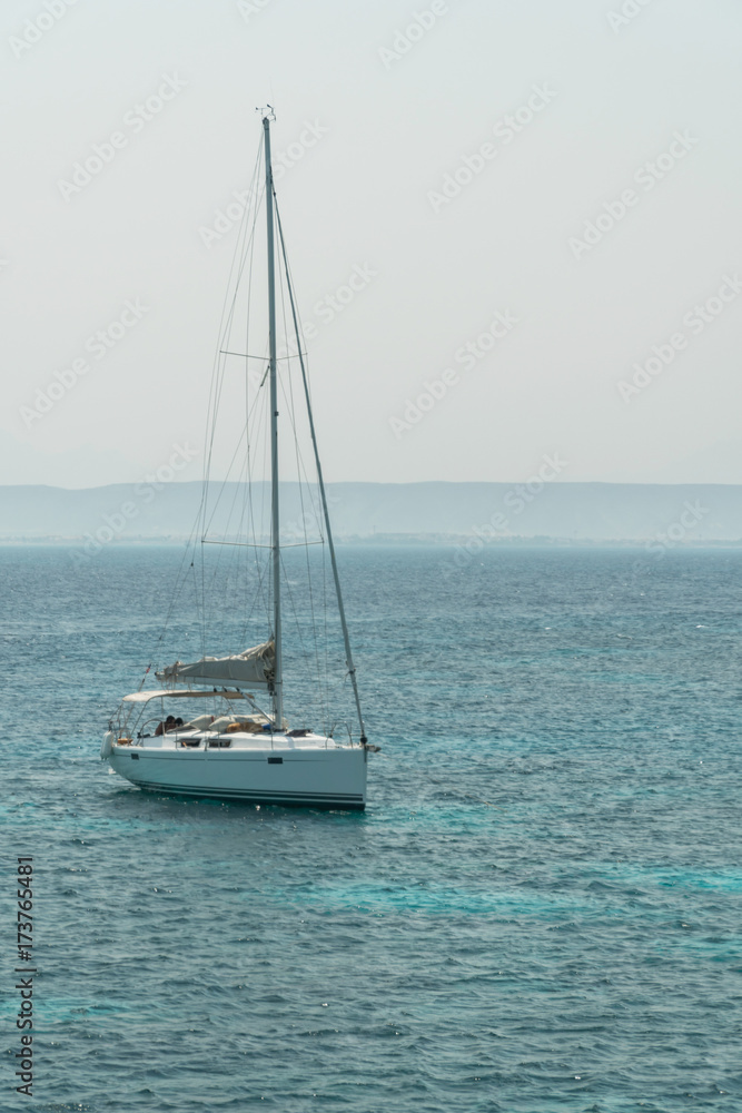 A sailing yacht under way on tropical sea