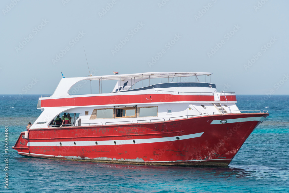 A motor yacht under way on tropical sea A motor yacht under way on tropical sea