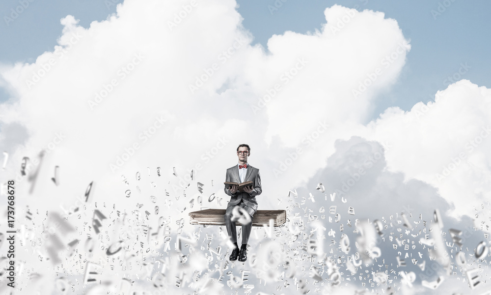 Young businessman or student studying the science and symbols fl Young businessman or student studying the science and symbols fl