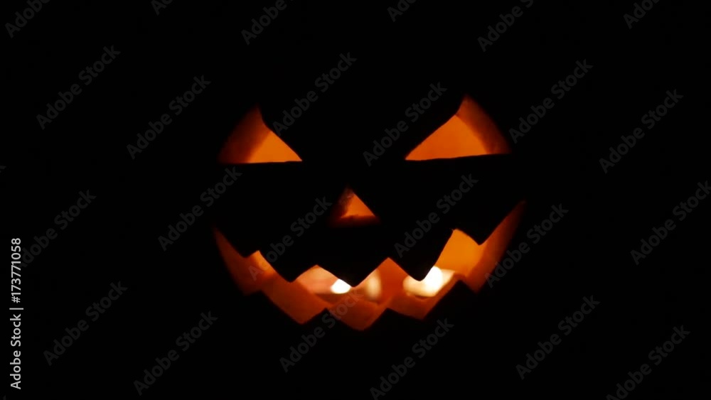 halloween jack-o-lantern burning in darkness halloween jack-o-lantern burning in darkness