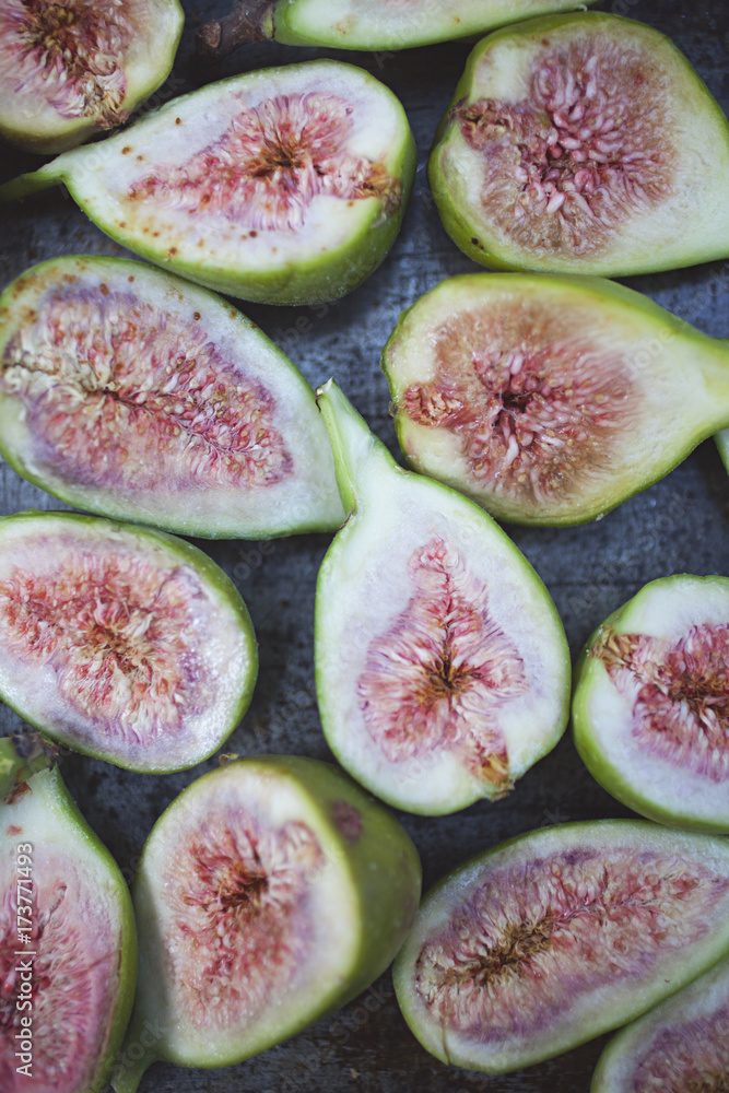 Homegrown organic figs cut in half on tray sprinkled with sugar ready to bake Homegrown organic figs cut in half on tray sprinkled with sugar ready to bake