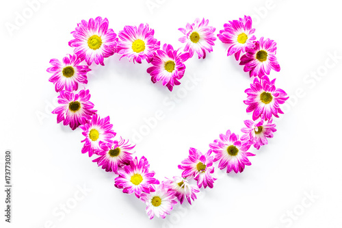 Floral frame. Heart of pink flowers on white background top view copyspace