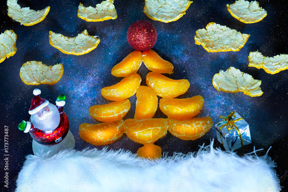 Christmas fir-tree with a santa and a gift in the background of the starry sky. Symbol of the New Year and Christmas
