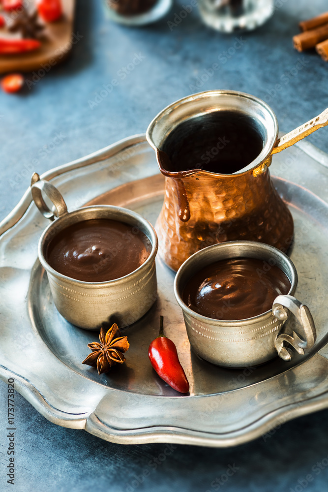 Spicy Spanish Hot Chocolate in Two Metal Cups with Pot on Tray Spicy Spanish Hot Chocolate in Two Metal Cups with Pot on Tray