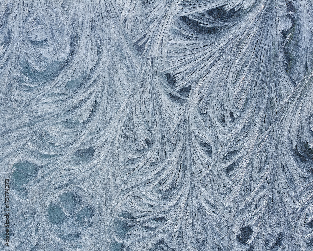 Fototapeta premium beautiful holiday background of intricate frosty pattern on glass