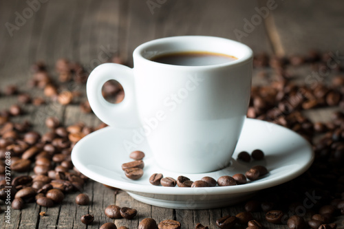 A white set of coffee on wooden and sacking background with cinnamon and coffee beans