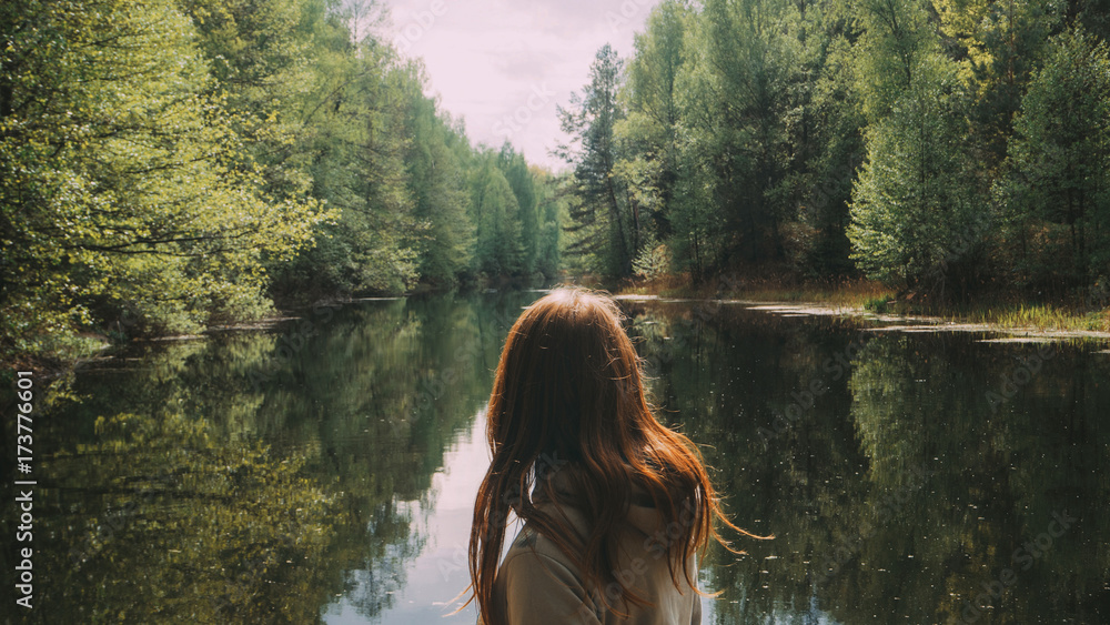 girl stands with his back to the camera. against the background of a ...