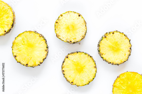 Pattern of round pinneapple slices on white background top view