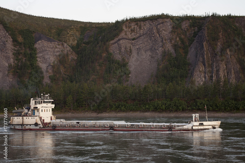 The ship carrying fuel on a mountain river. The River Indigirka. The Republic Of Sakha. Russia.