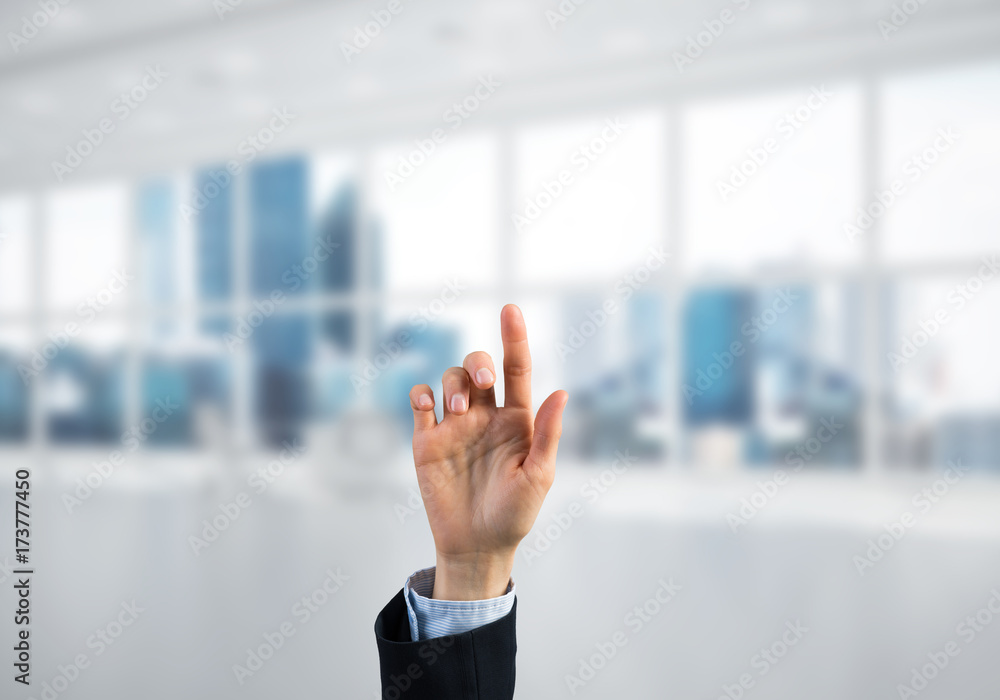 Choosing gesture of businessperson in elegant modern interior in sunshine light Choosing gesture of businessperson in elegant modern interior in sunshine light