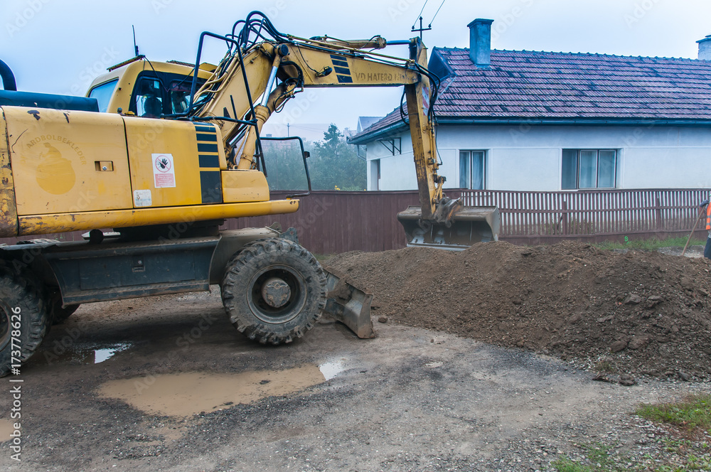 Moving the muddy soil with the excavator. Moving the muddy soil with the excavator.