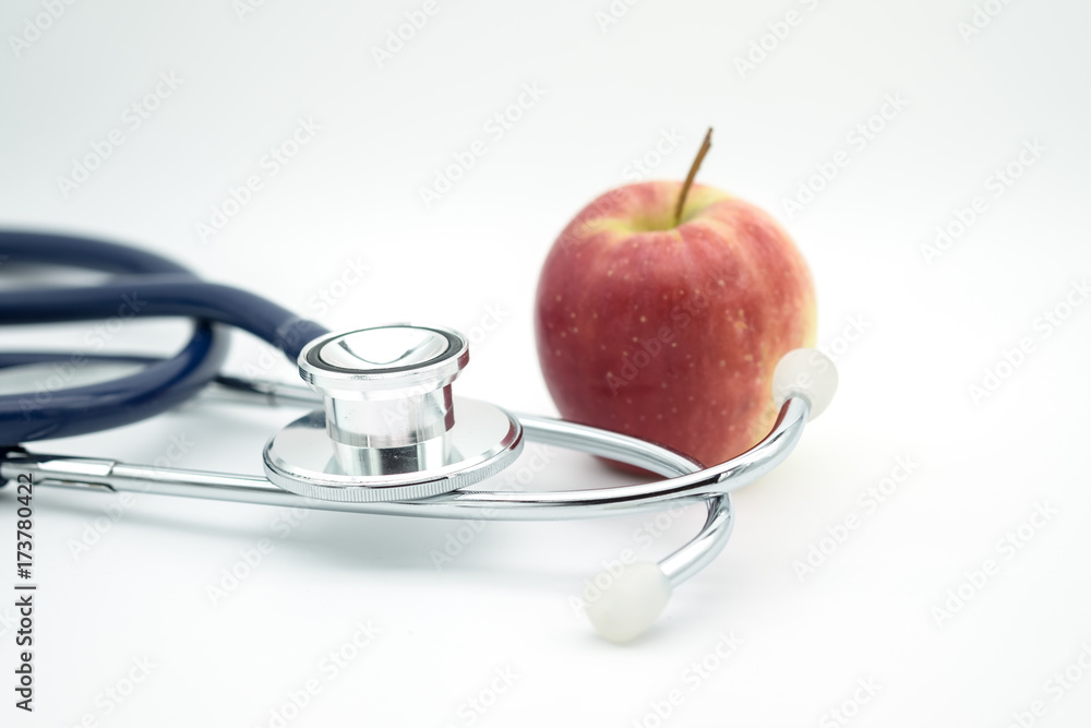 Healthcare and food concept. Close up of Stethoscope with apple on white background Healthcare and food concept. Close up of Stethoscope with apple on white background