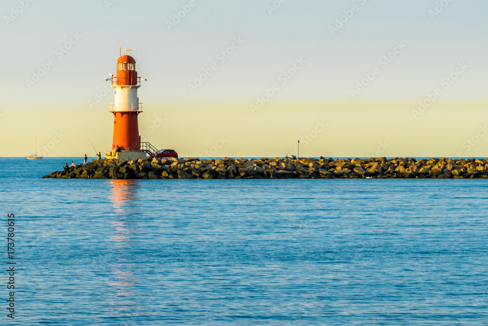 red lighthouse of Warnemuende on the Baltic Sea at the harbor , 