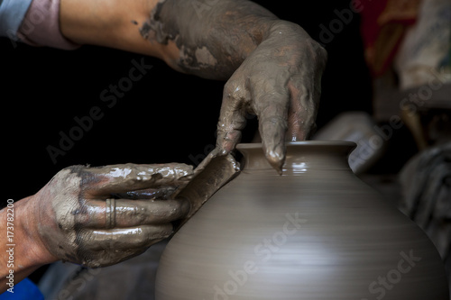 Details of hands making pottery. photo