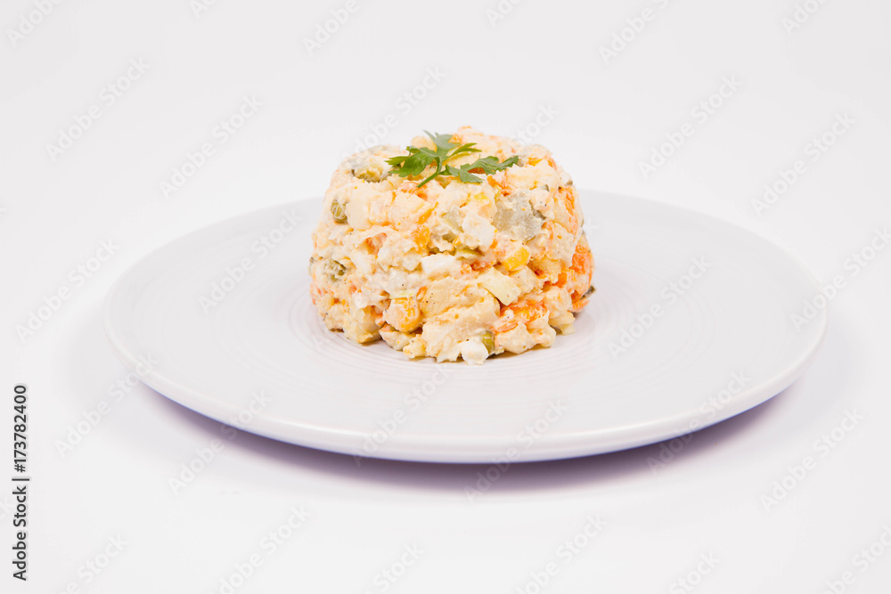 Vegetable salad (potato, carrot, corn, pea, egg, leek) with mayonnaise on a white background Vegetable salad (potato, carrot, corn, pea, egg, leek) with mayonnaise on a white background