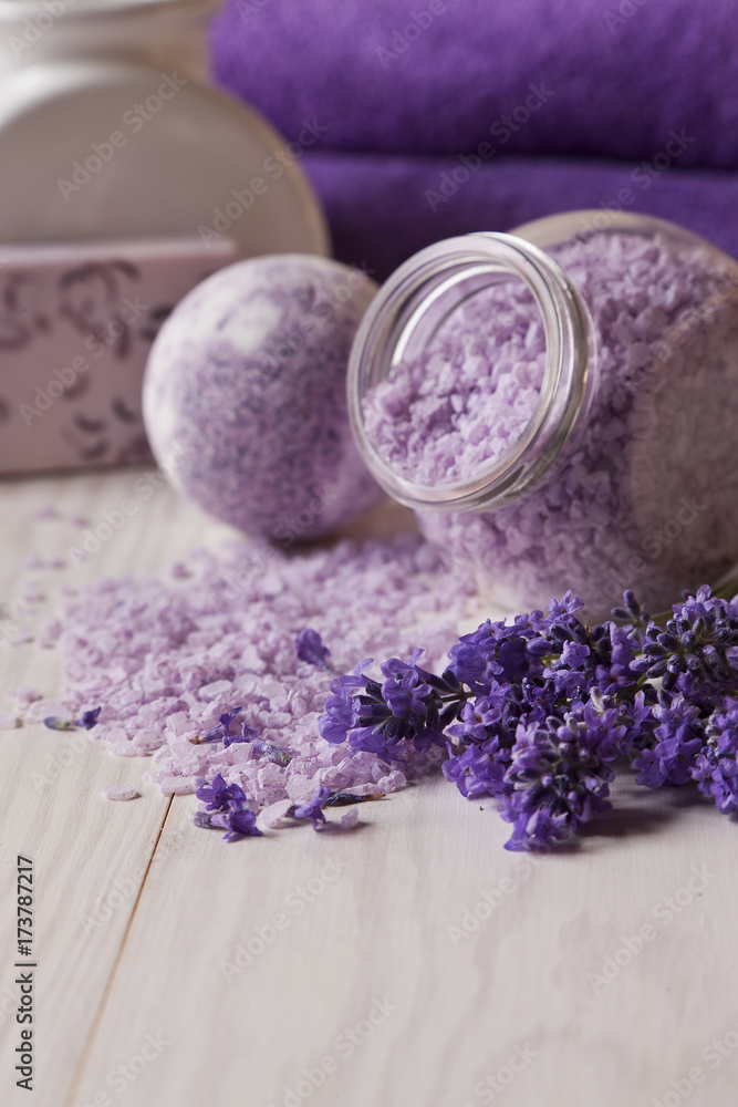 Lavender flowers, lavender soap, aromatic sea salt and towels. Spa kit for beauty and health on a white wooden background. Close up. Lavender flowers, lavender soap, aromatic sea salt and towels. Spa kit for beauty and health on a white wooden background. Close up.