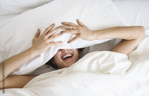 Happy smiling young woman in the bed