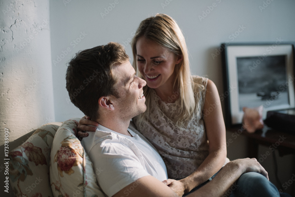 Girl sitting on boyfriends lap laughing Stock Photo | Adobe Stock
