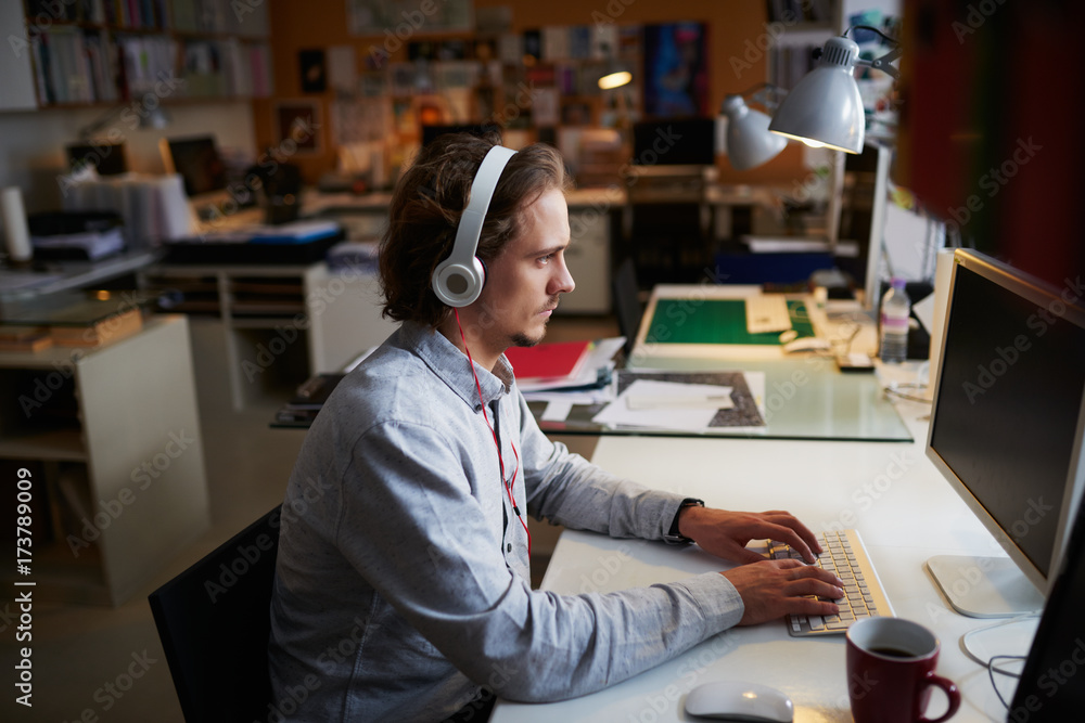 Start up businessman working at computer in busy office Start up businessman working at computer in busy office