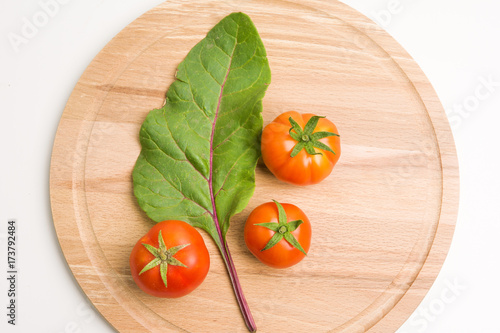 Fresh Tomatoes From The Garden On Wooden Plate Closeup Top View