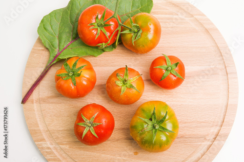 Fresh Tomatoes From The Garden On Wooden Plate Closeup Top View