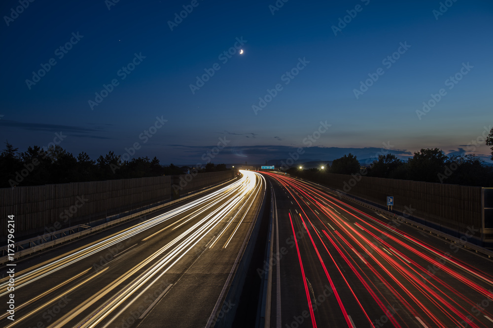 colorful light trace from highway traffic at night 