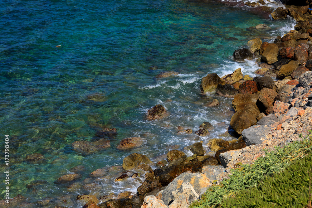 Beautiful sea wave background on the stones near the shore and foam. Contrast portrait