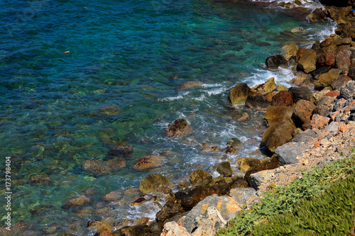 Beautiful sea wave background on the stones near the shore and foam. Contrast portrait